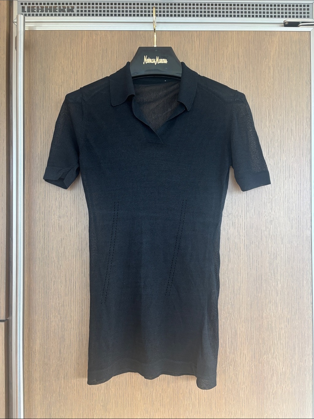 Black Short-Sleeve Polo Knit with transparent effect.